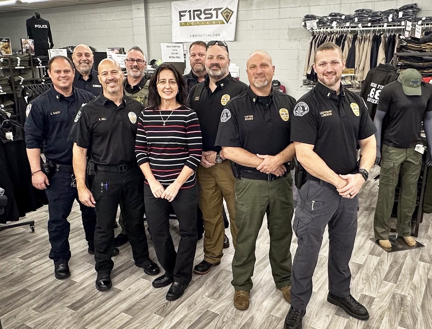 Law enforcement officers in uniform with ES Tactical staff in the store